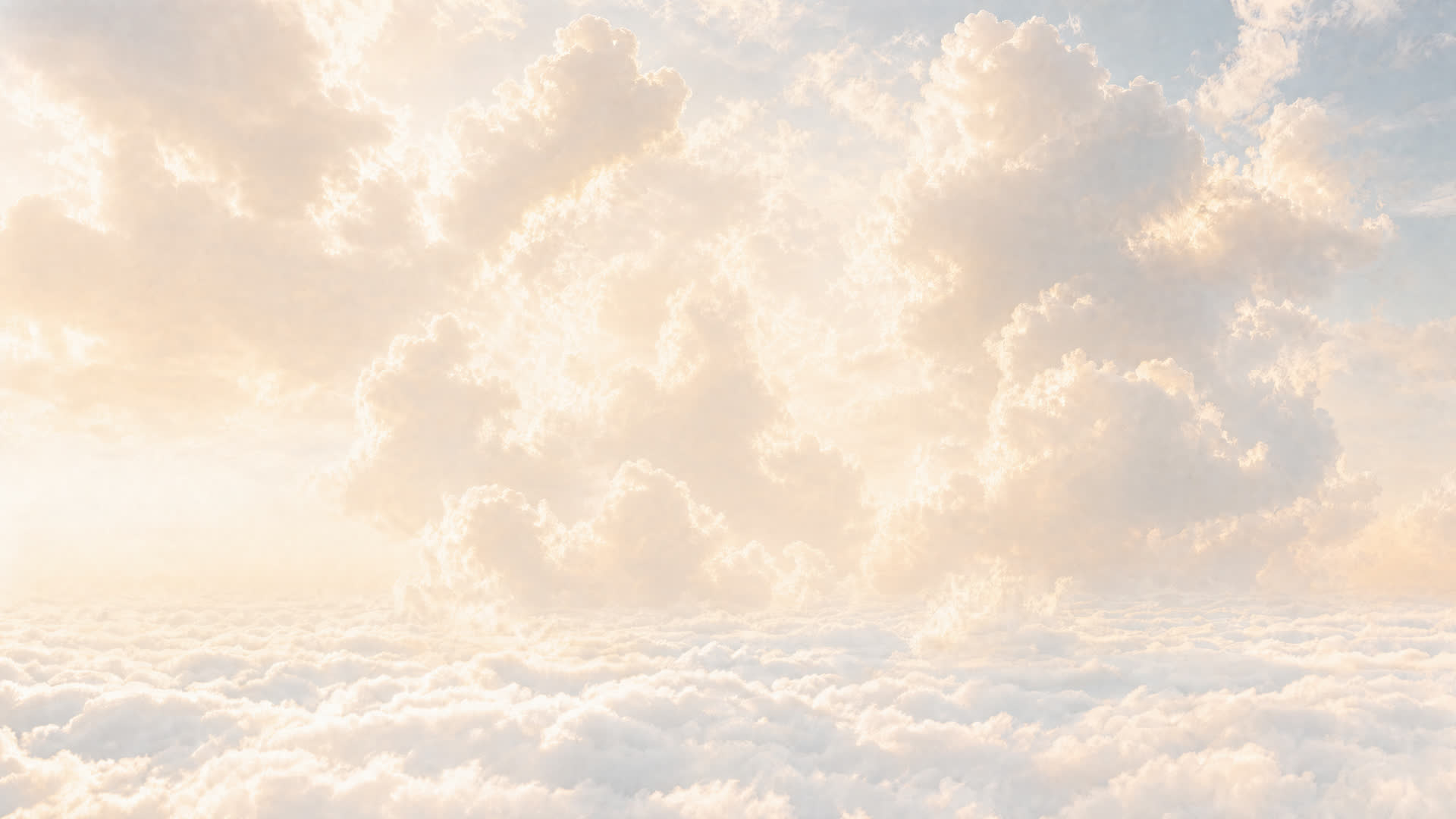 A sea of sunlit clouds stretches to the horizon under a soft blue sky